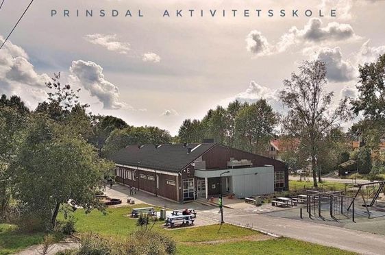En bygning med trær og gress