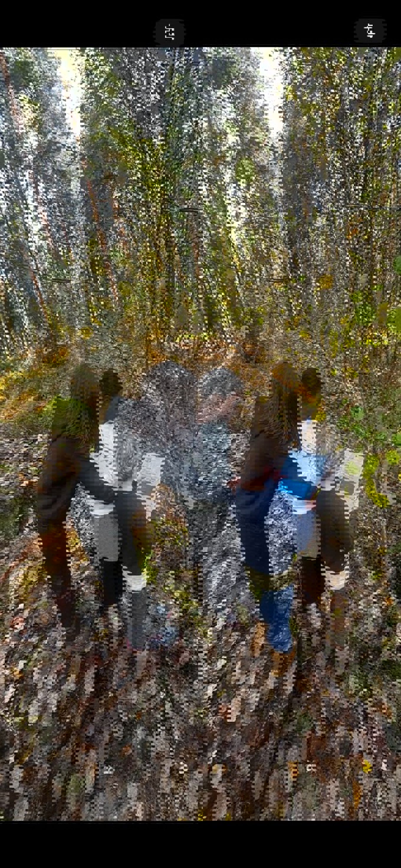 en person og to barn som ser på et nettbrett